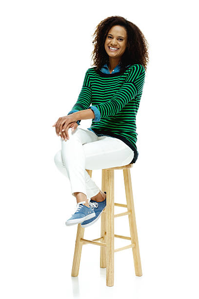 istock Smiling woman sitting on stool 505266282