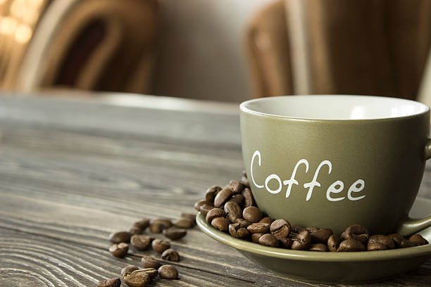 istock cup of coffee with grains on a wooden table 505267362