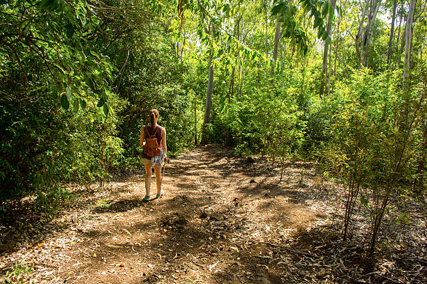 istock Girl walking down a slope through the jungle 505267986