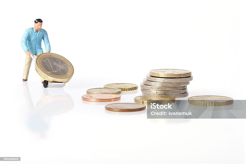 Trabajador en miniatura de unidades de monedas en euro - Foto de stock de Figurita libre de derechos