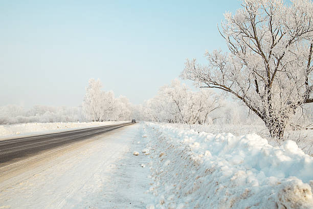 istock Car on a winter road in the woods leaving afar 505268408