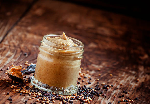 istock Freshly prepared mustard sauce in a small glass jar 505268662
