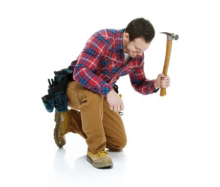 Smiling carpenter kneeling and workinghttp://www.twodozendesign.info/i/1.png