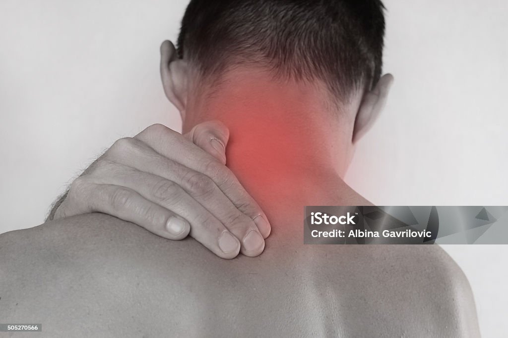 Man rubbing his painful neck. Pain relief concept Close up of man rubbing his painful neck. Pain relief concept Adult Stock Photo