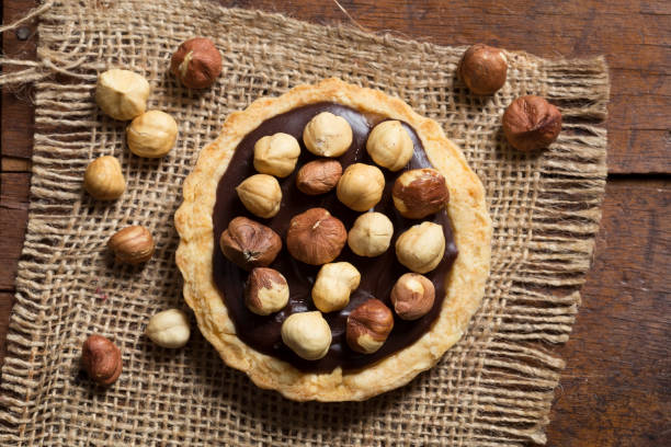 istock Chocolate and caramel tart with hazelnuts 505274424
