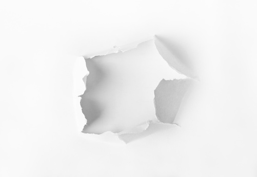 Hole punched in the paper - concept background