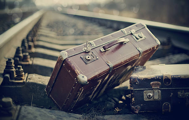 istock Old vintage suitcases on railway rails. 505274936