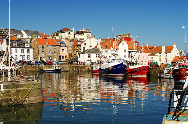 Pittenweem Harbour The traditional fishing village of Pittenweem on the Fife Coast, Scotland on a calm summer day. fishing village photos stock pictures, royalty-free photos & images