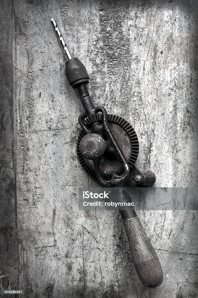 Vintage Hand Drill with Grunge Effects Vintage hand drill over timber.  Grunge effects. Aerial View Stock Photo