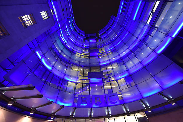 BBC London, UK - January 16th 2016:Night time shot of the floodlit front elevation of BBC News Broadcasting house  offices in central London -  the HQ of the British Broadcasting Corporation bbc photos stock pictures, royalty-free photos & images