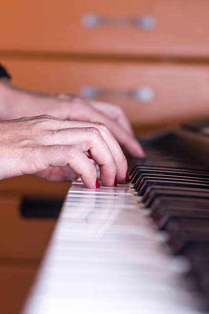 istock Close-up of hands playing the piano 505292510