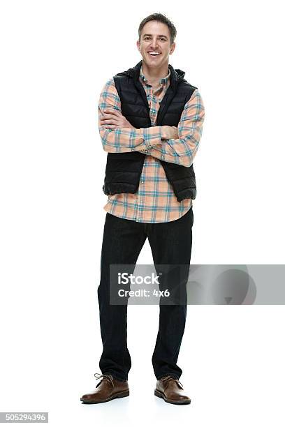 Smiling Casual Woman Standing With Arms Crossed Stock Photo - Download Image Now - Men, Ski Vest, Full Length