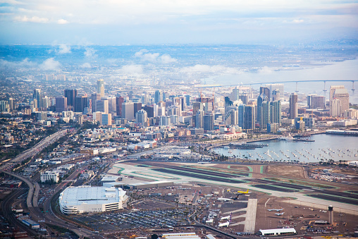 An aerial view of the San Diego skyline with the airport in the foreground.