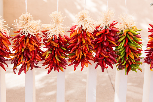 An iconic Santa Fe scene of chilies strung on rope and hung to dry outside. 