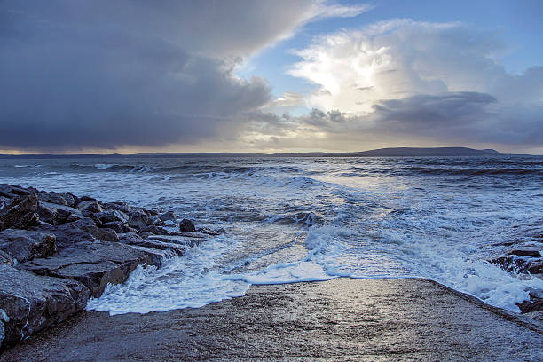 Stormy sea at sunrise - Pembrey Harbour, South Wales, UK