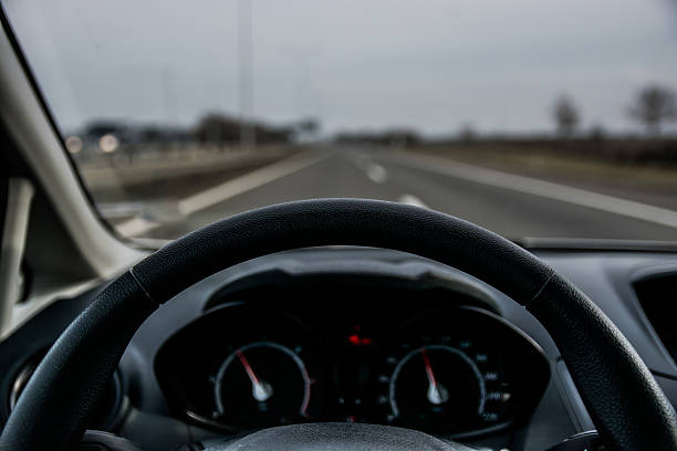 istock Car drivers view on a steering wheel and the road 505296560