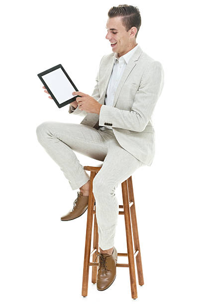 istock Smiling businessman pointing at tablet 505298818