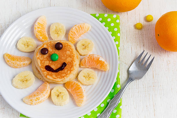 istock Pancakes with fruit for the children. Top view 505301302