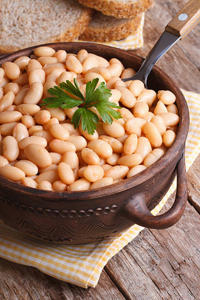 istock boiled white kidney beans in pot and bread, closeup 505301541