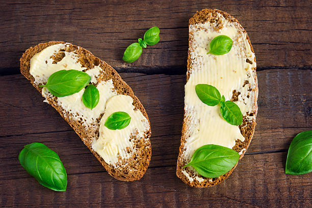 istock Two sandwiches of rye bread with butter and basil. 505302872