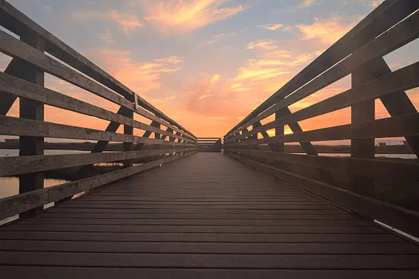 Photo of Wooden Boardwalk at sunset at Bolsa Chica