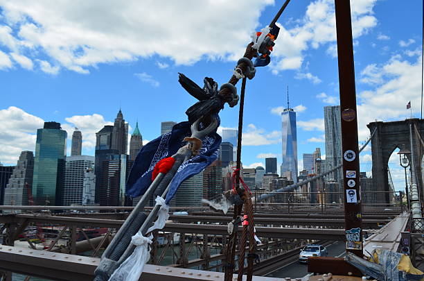 Good Luck: Omikuji at the Brooklin bridge, New York City New York City, NY, USA - June 6, 2014: Omikuji (Japanese fortune strips) knotted to the Brooklyn bridge. liberty tower stock pictures, royalty-free photos & images