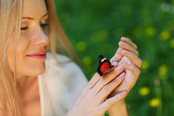 istock Woman playing with a butterfly 505304943
