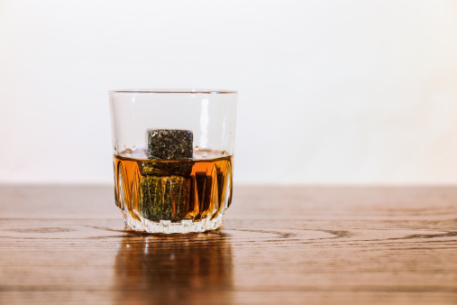 Whisky drink poured onto whisky stones