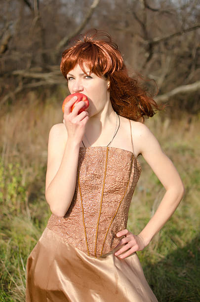istock Redhead woman eating an apple 505305453