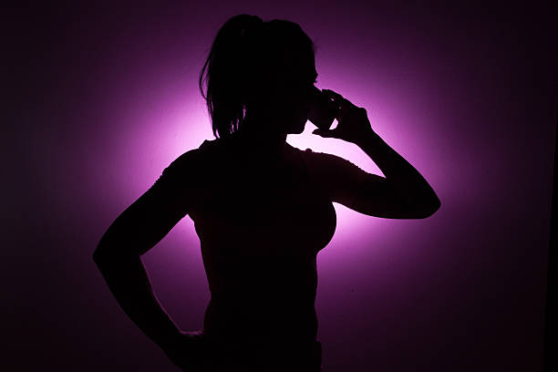 Silhouette girl who talking on her phone.
