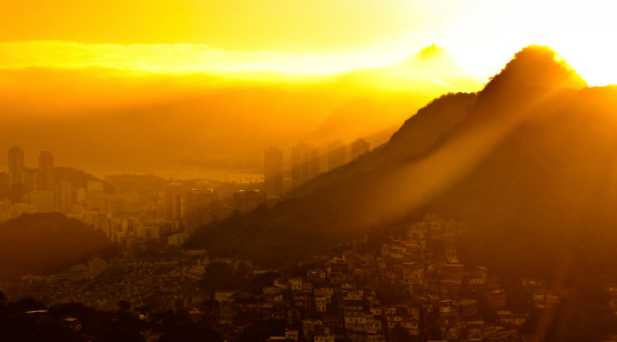 Sunrise in Rio de Janeiro, Sun shines above hills in Urban Area.