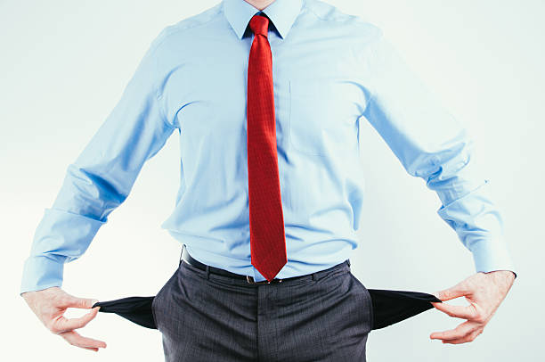 istock Bankrupted businessman in formal outfit showing empty pockets 505307411