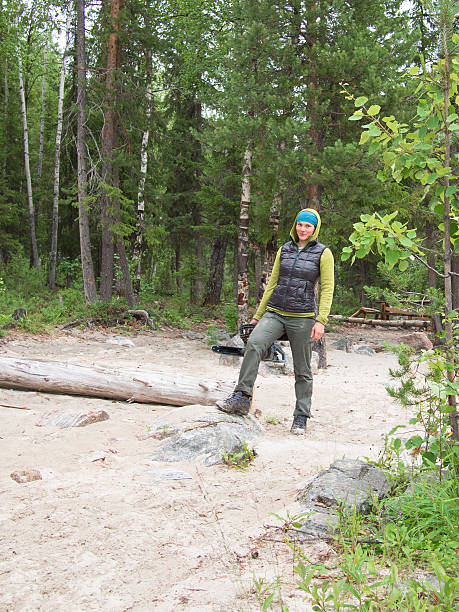 Young woman with a power saw standing on the sand