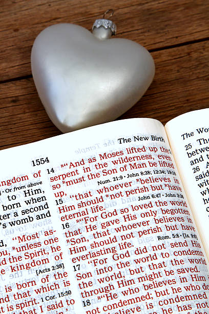 istock Religious: open Bible Scripture of John 3:16 with white heart 505326464