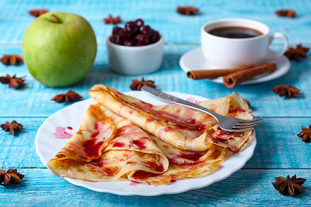 istock Breakfast pancakes with cherry jam on a blue background 505329416