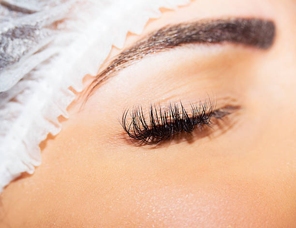 istock Beautiful young woman eyelash extension 505335778