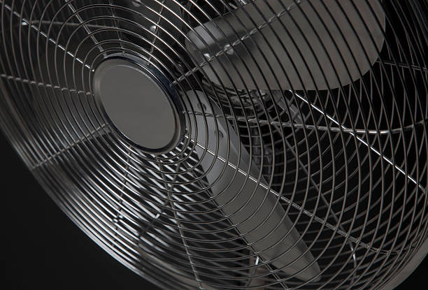 istock closeup metal fan on black background 505337688
