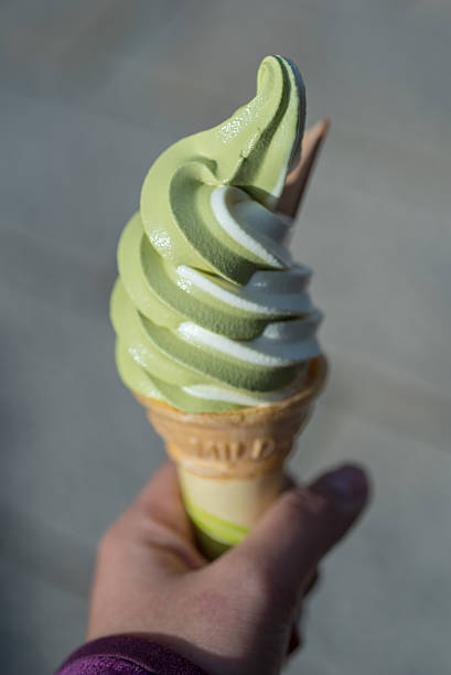 istock closed up the hand is holding soft greentea iced-cream, Japan 505339268