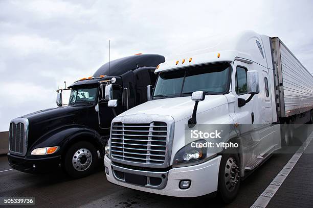 Two Contrast Modern Semi Truck Different Models Black And White Stock Photo - Download Image Now