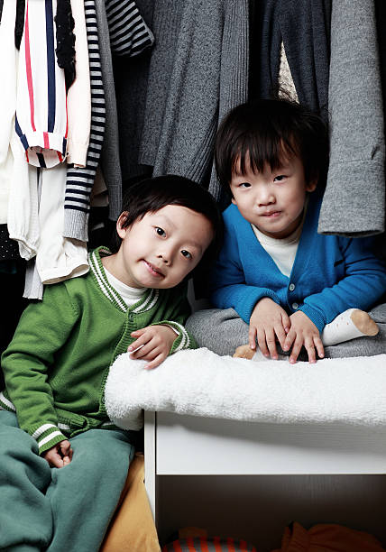 istock Brother playing in the closet 505340186