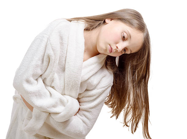 istock girl has a stomachache with bathrobe, isolated on white backgrou 505342182