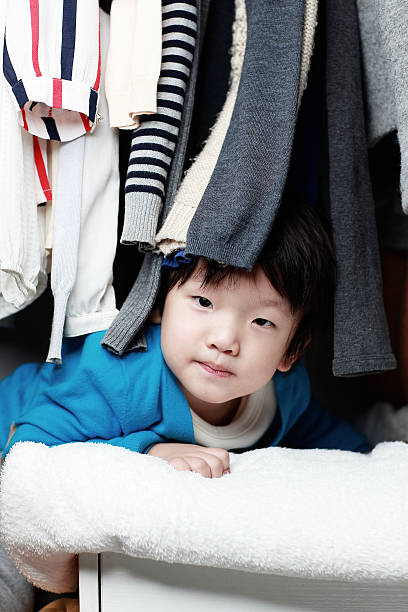 istock Child playing in the closet 505343090