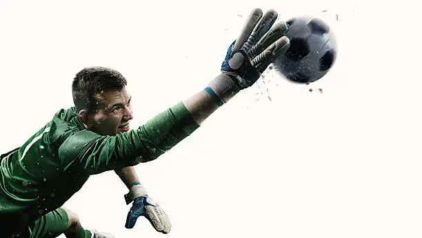 Isolated professional soccer goalkeeper in action. A player wears unbranded soccer uniform.