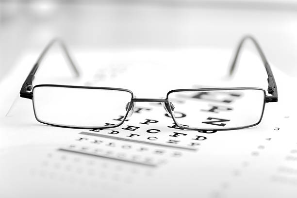 istock Clear Black modern glasses on eye sight test chart 505365415