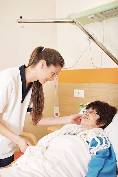 istock Nurse Looking at a Patient in Caring Way 505366203