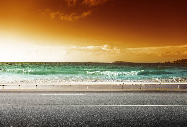 istock road and sea in sunset time 505368845