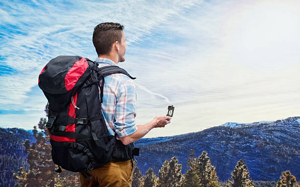 istock Hiker holding compass in wilderness area 505370704