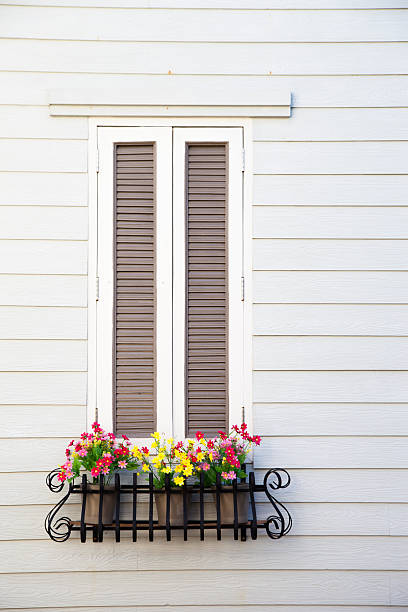 istock Classic white window with flower planter box 505370775