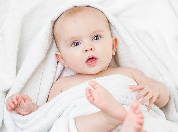 istock Cute baby girl lying on white towel 505371098