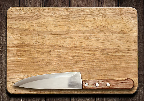 istock Cutting board and knife on old wood table 505373184